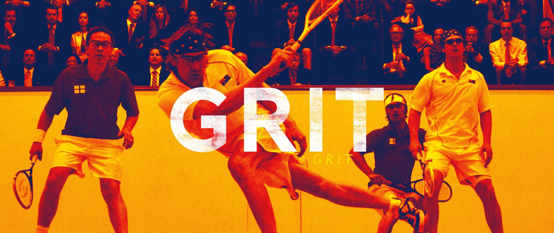 Squash players showing grit and determination during intense match with crowd watching behind them.